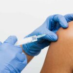 Person getting a vaccine injection during clinical trial