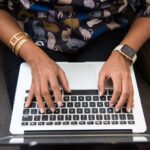 Person typing on laptop and using autocomplete text fields