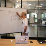 Man sketching eCRF design on a whiteboard