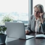 Woman using a laptop for a remote audit video meeting