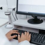 Medical professional typing on computer and using Multiple Subject Data Entry