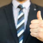 Auditor in suit giving a thumbs up to clinical study design